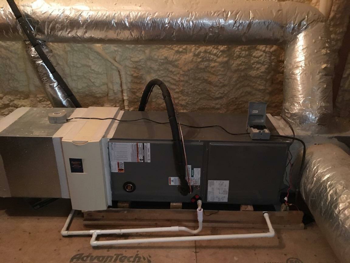 JD Heating and Air technicians installing commercial ductwork in a large building