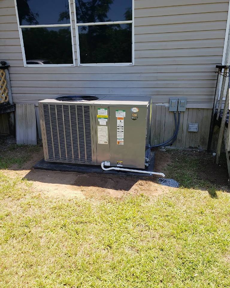 JD Heating and Air technician performing a professional air conditioning installation at a residential property in Statesboro Georgia